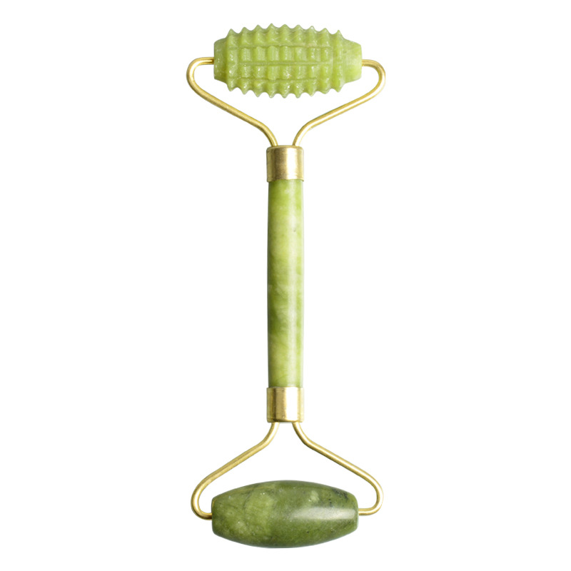 Green double-ended facial roller with one textured and one smooth head.