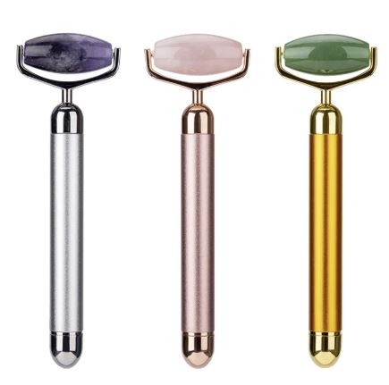 Silver, rose gold and gold electric facial rollers shown side by side.