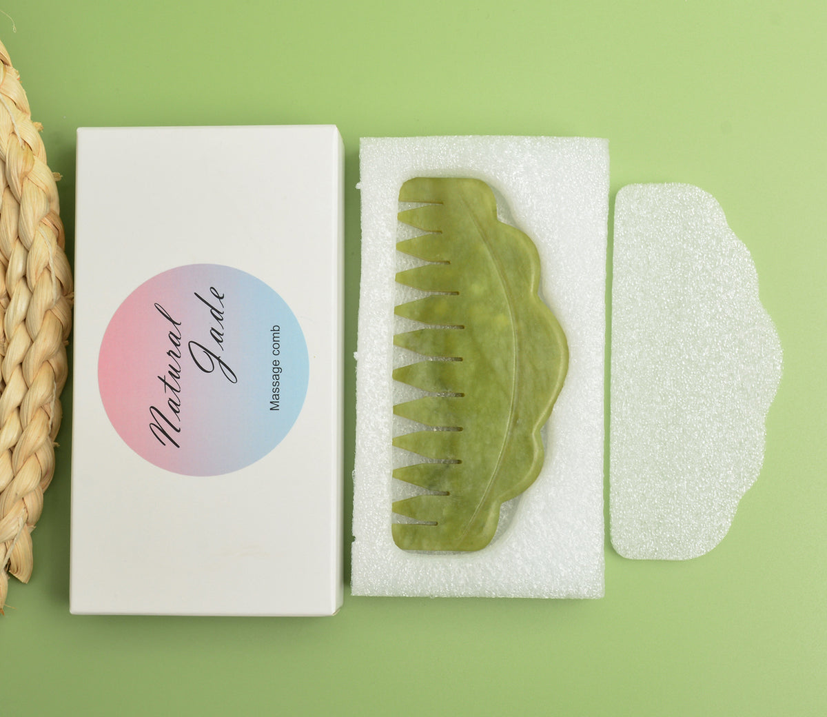 Green jade scalp massage comb in a white padded presentation box.